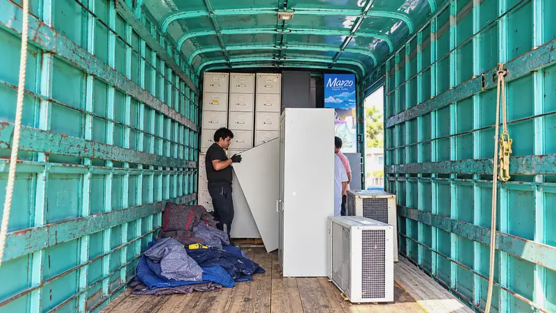 Crew arranging protected furniture inside the truck